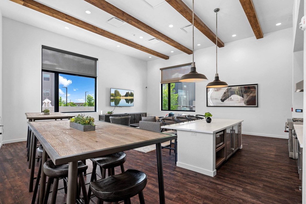 A modern kitchen with a wooden table and chairs.