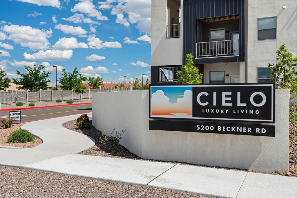 A sign for Cielo Luxury Living stands in front of a building.