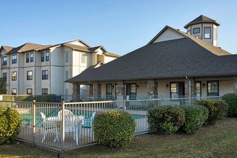 A large building with a pool in front of it.