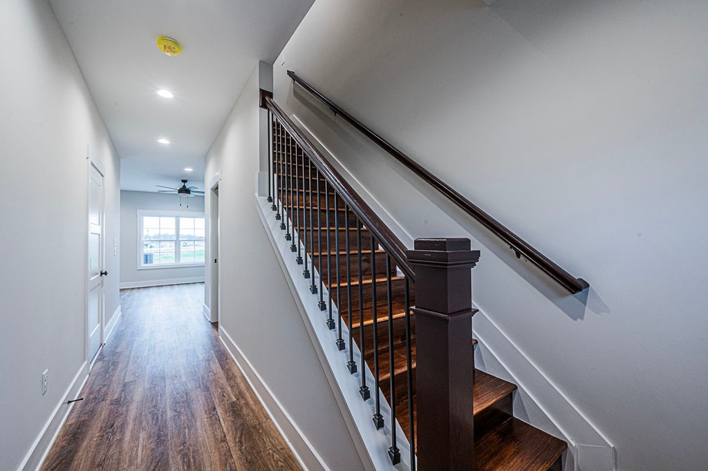 A long hallway with a staircase on the right side.