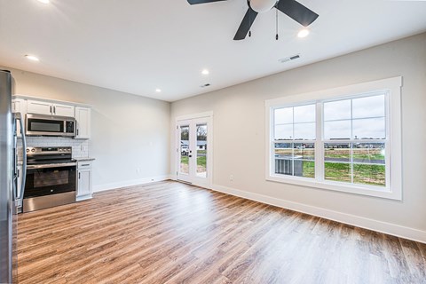 A spacious kitchen with a refrigerator, oven, and microwave.