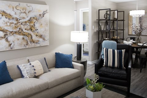 a living room with a couch and a chair and a table