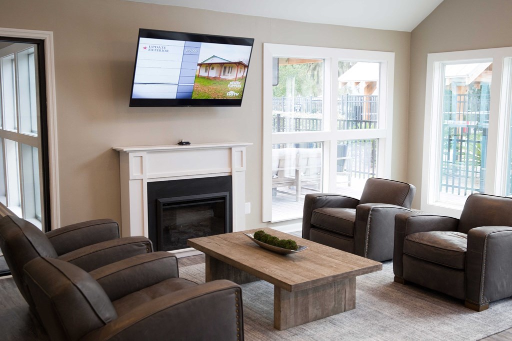 a living room with couches and a table and a television