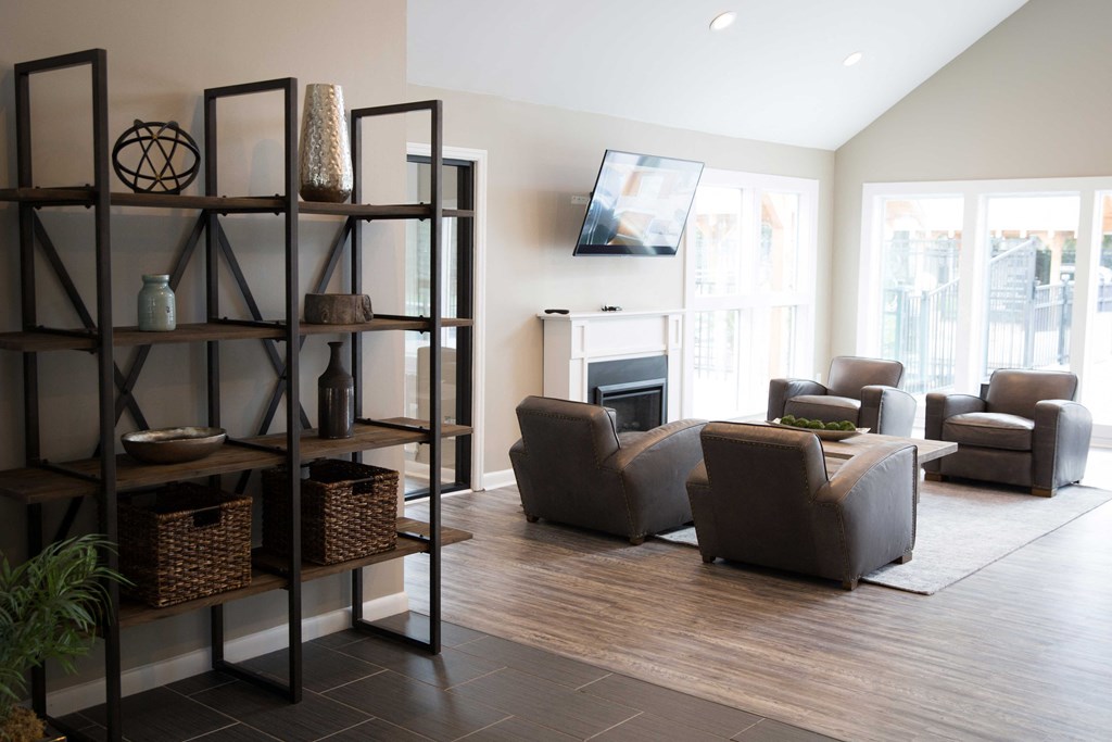 a living room with couches and chairs and a fireplace