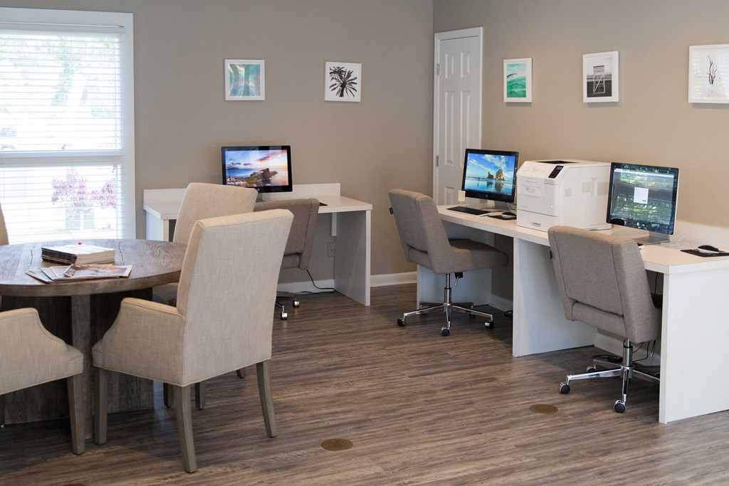 a group of computers sitting on desks in a room