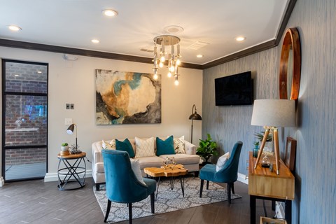 a living room with blue chairs and a white couch