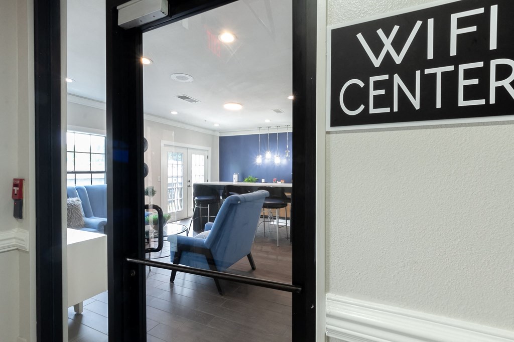 a view of a living room with a wifi center sign in a window