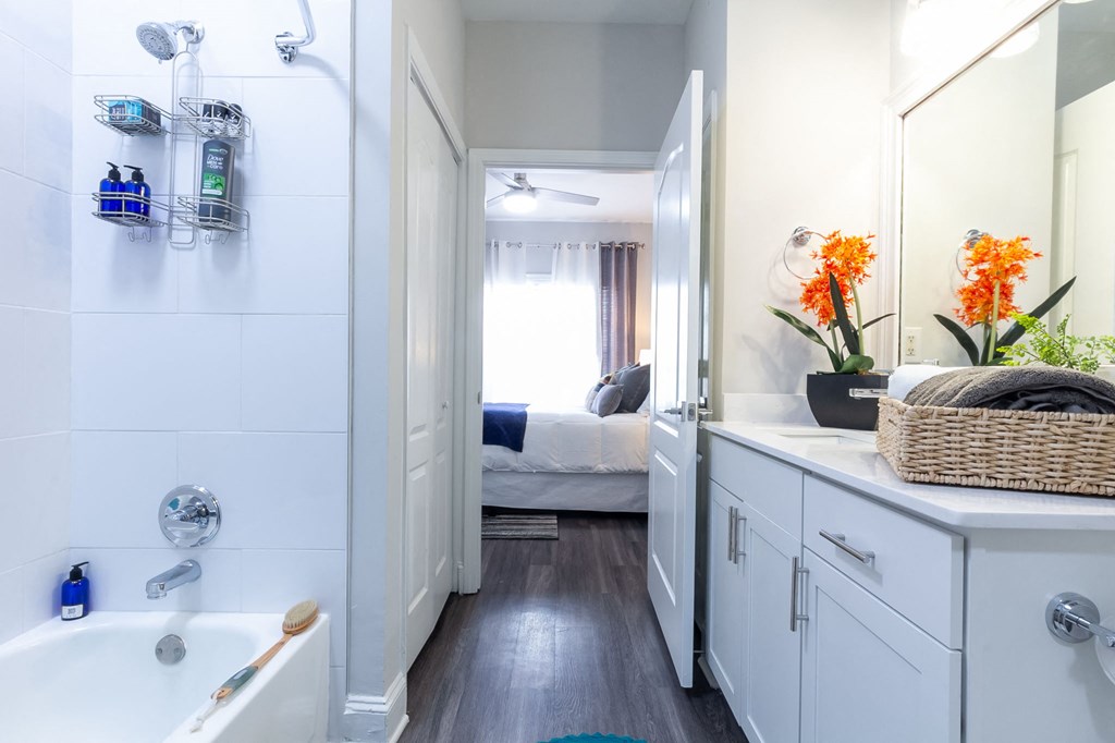 a bathroom with a shower and a sink and a mirror