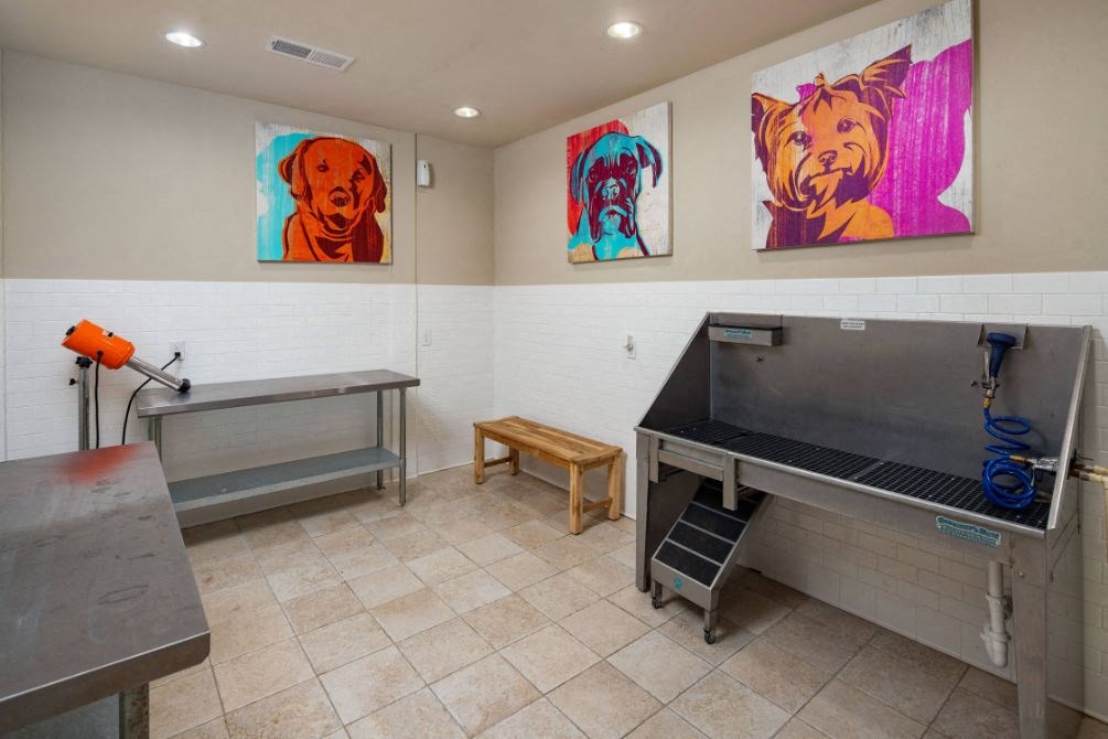 a room with two tables and three paintings on the wall