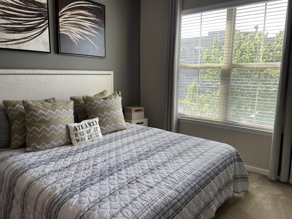 a bedroom with a bed and two windows