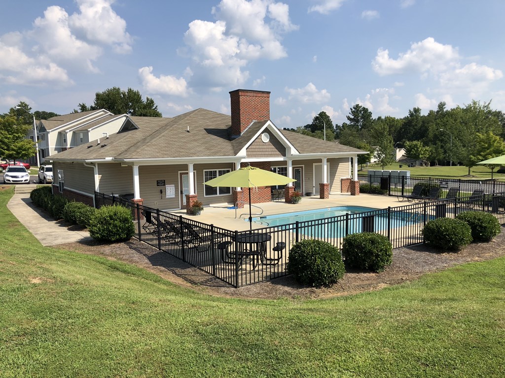 a large yard with a pool and a house