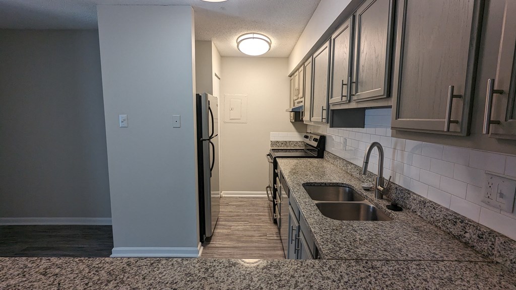 a kitchen with granite countertops and stainless steel appliances