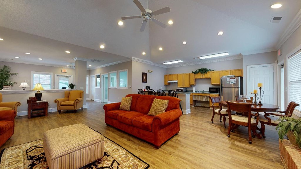 a large living room with a couch and a kitchen