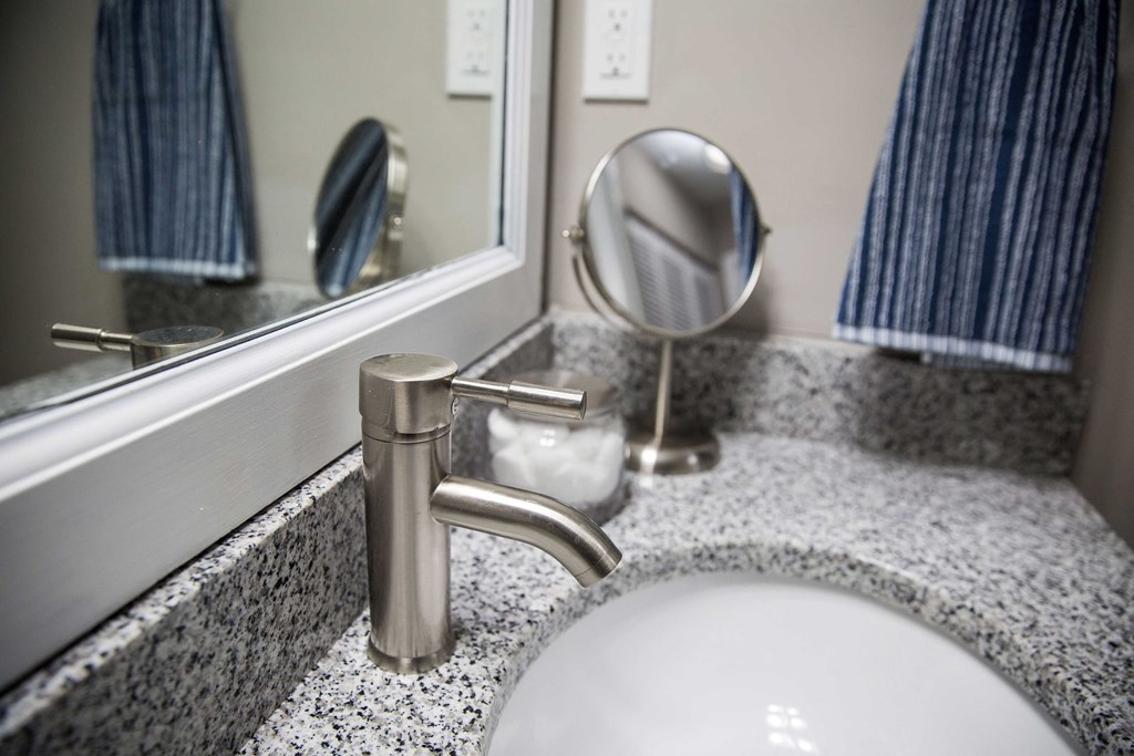 a bathroom sink and mirror in a hotel room