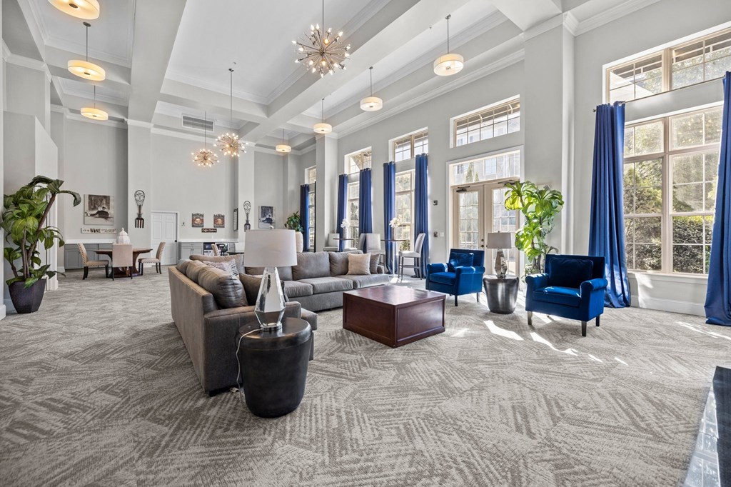 a large living room with couches and chairs and large windows