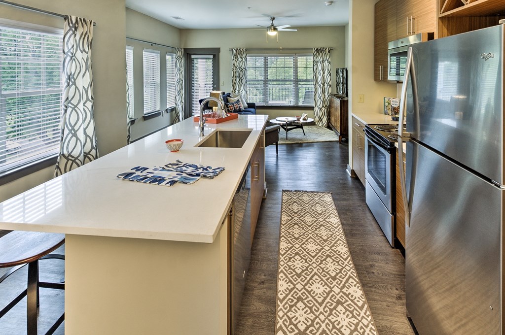 a kitchen with stainless steel appliances and a white counter top