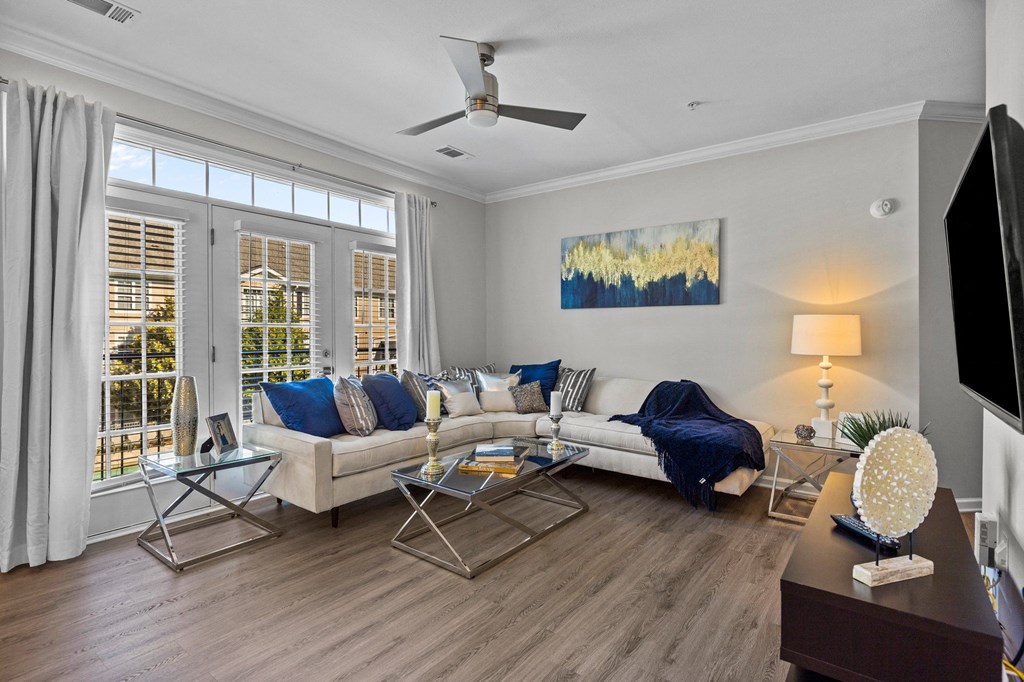 a living room with a couch and a ceiling fan