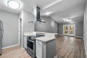 a kitchen with a stove top oven next to a refrigerator