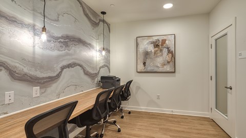 A room with a marble wallpaper and a painting on the wall.