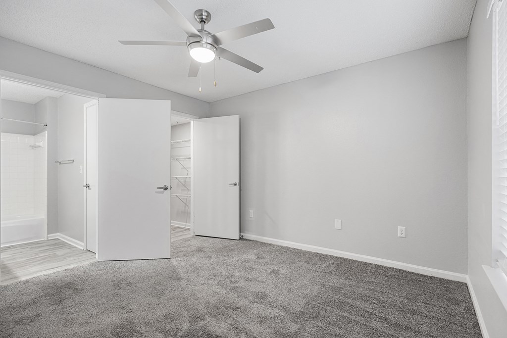 an empty room with white walls and a ceiling fan at Midtown Crossing in Raleigh, NC 27609