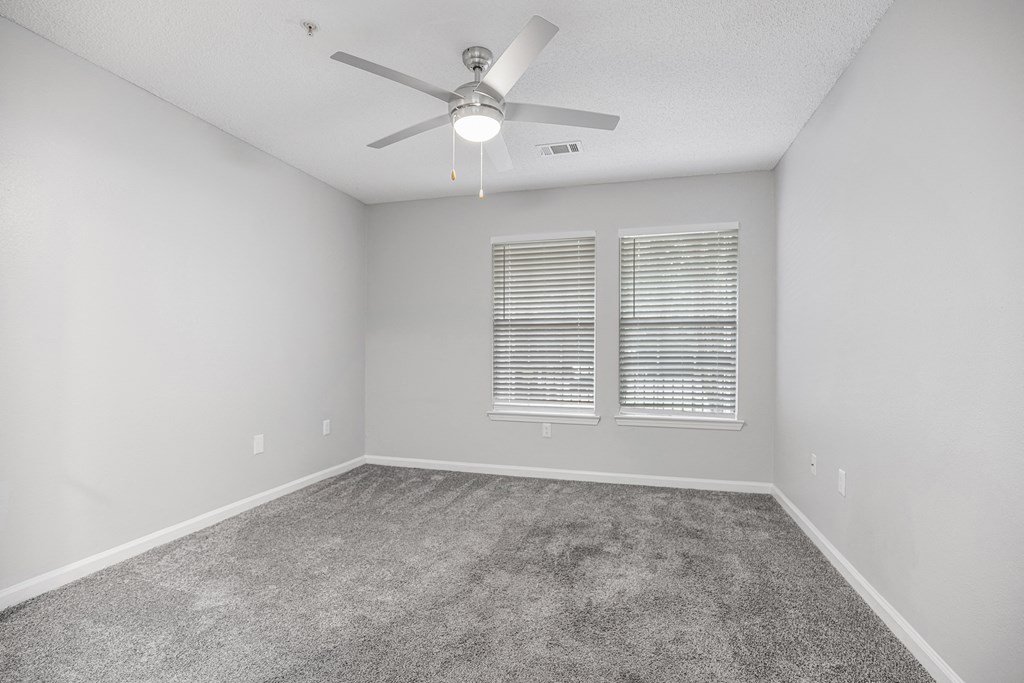 an empty room with a ceiling fan and a window at Midtown Crossing in Raleigh, North Carolina 27609