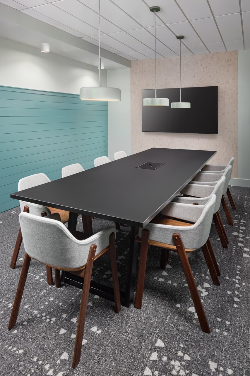 A conference room with a long table and chairs.