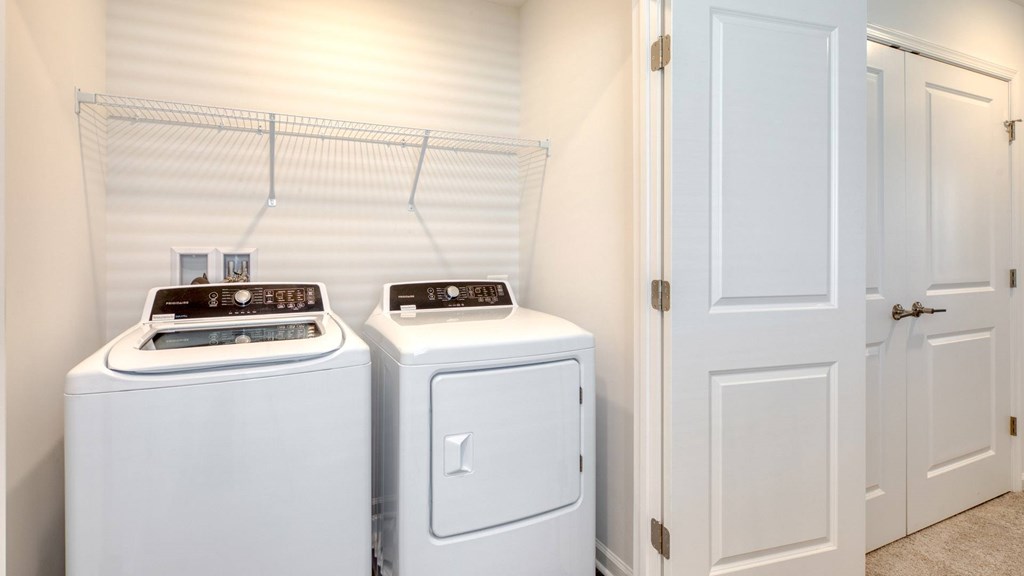 Two white front load washing machines in a laundry room at The Mark Townhomes Apartments, Harrisonburg, VA