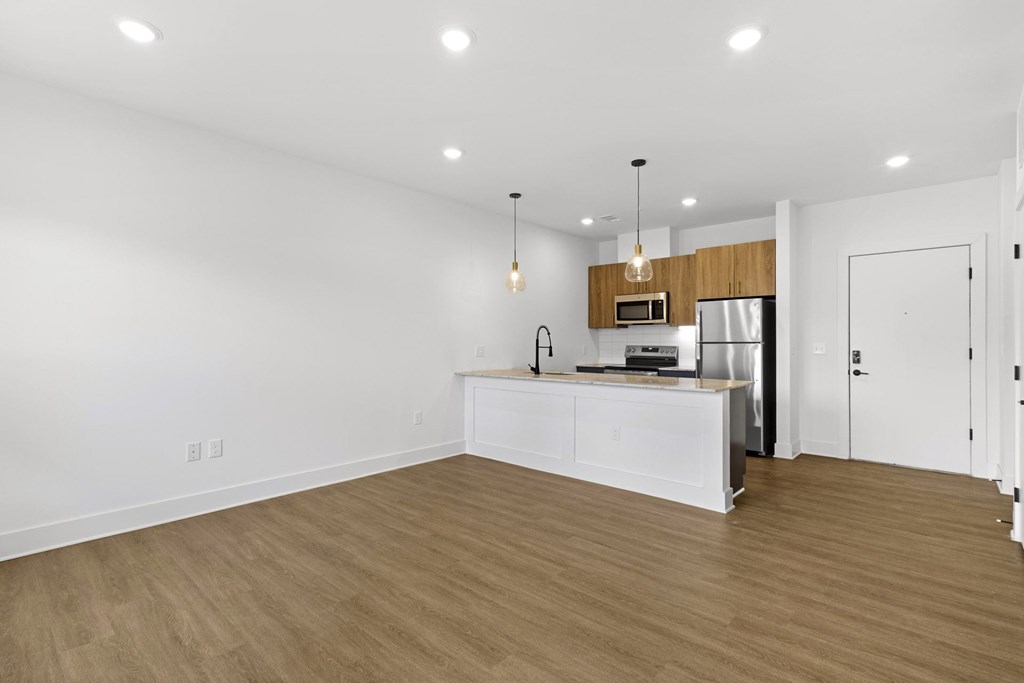 A kitchen with white cabinets and a wooden countertop.