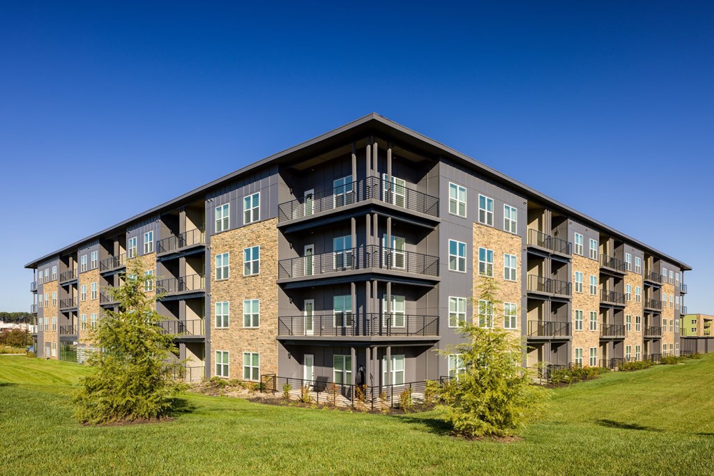 A large apartment building with balconies and multiple windows.