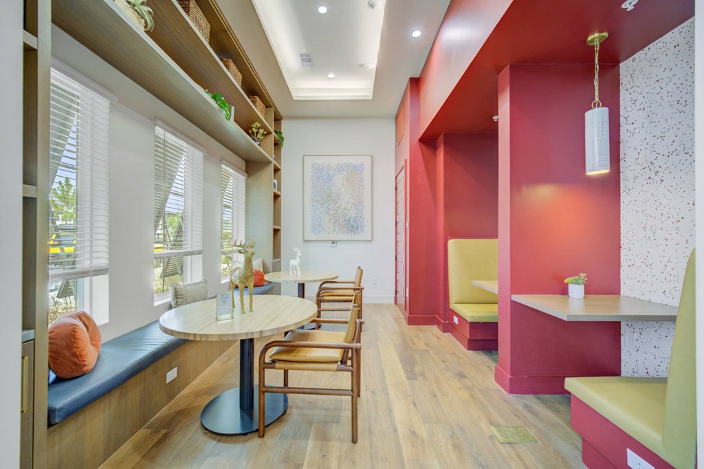 A room with a table and chairs and a bench.