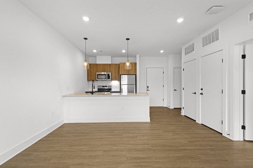 A kitchen with white cabinets and a wooden island.at Boardwalk at Research Park, Huntsville Alabama