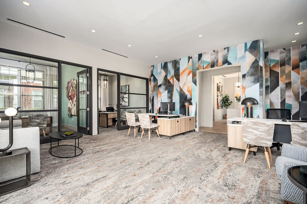 A modern living room with a grey carpet and wooden furniture.