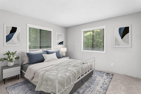 A bedroom with a large bed, a nightstand with a plant, and two framed artworks on the wall.