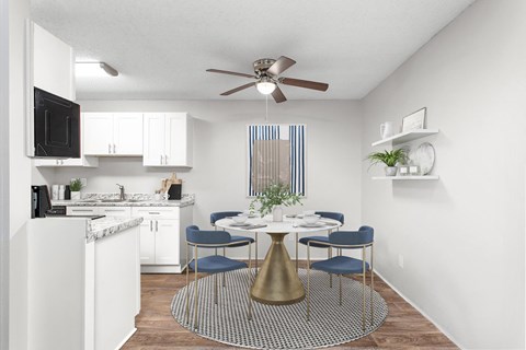 A kitchen with a dining table and chairs.