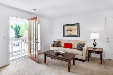 A living room with a white couch and a coffee table.