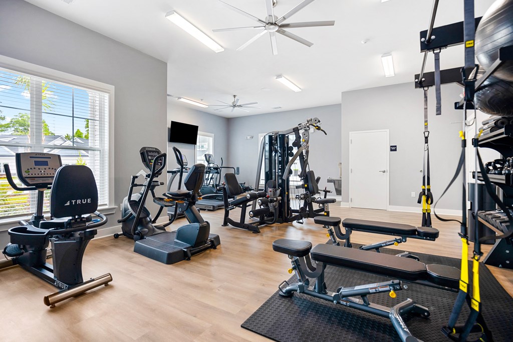 the gym with cardio machines and weights at the belgard apartments