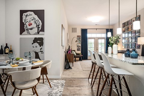 A dining room with a table set for a meal.