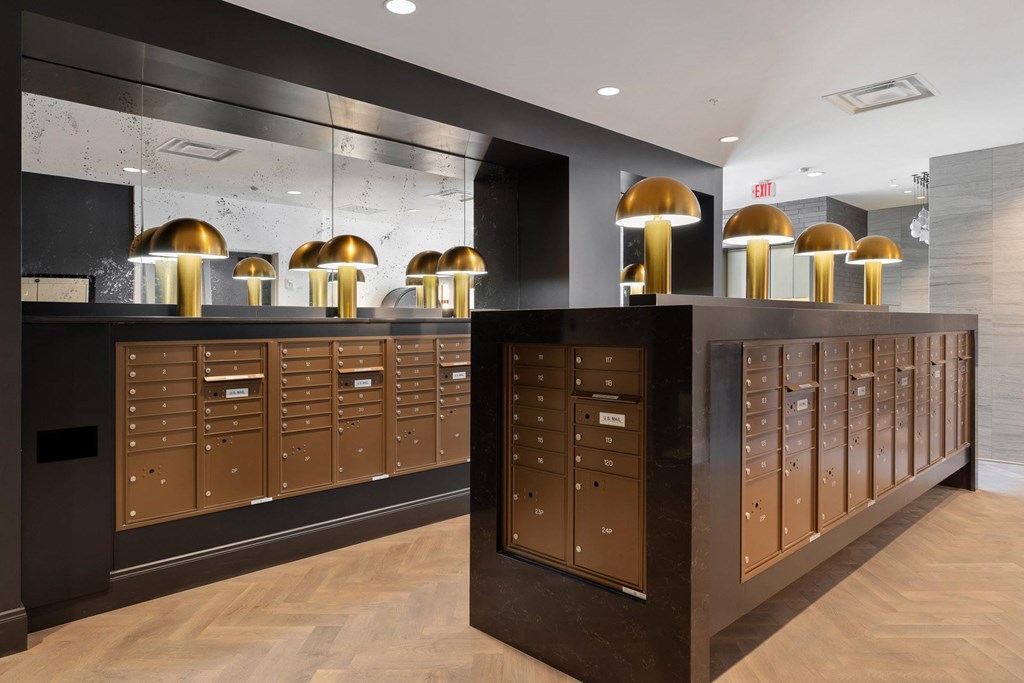 A row of brown mailboxes are lined up on a wall.