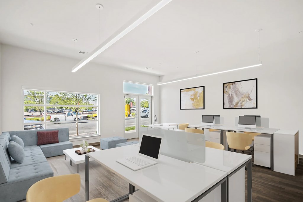 a living room with a desk and a couch and a windowat Metropolis Apartments, Glen Allen Virginia