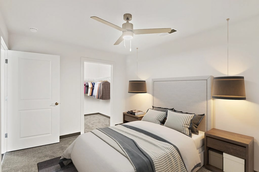a bedroom with a bed and a ceiling fanat Metropolis Apartments, Virginia