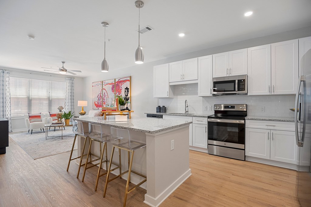 an open kitchen with an island with bar stools
