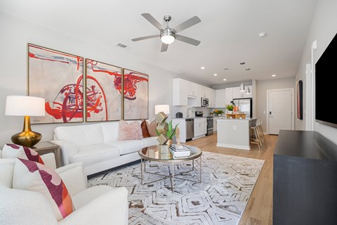 A modern living room with a white couch and a coffee table.