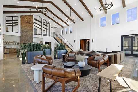 A living room with a brown leather couch and a white coffee table.