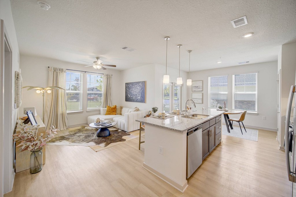 A well-lit, spacious kitchen and living room with a dining area.