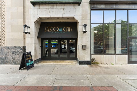 a sign on the sidewalk in front of a building