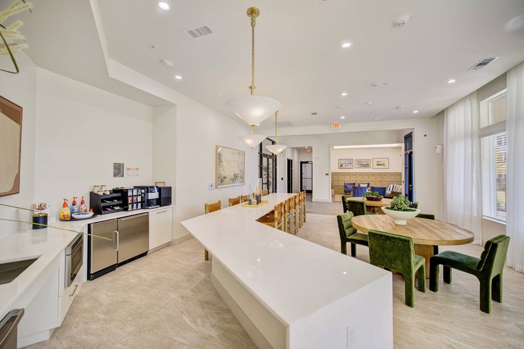 A modern kitchen with a dining table and chairs.