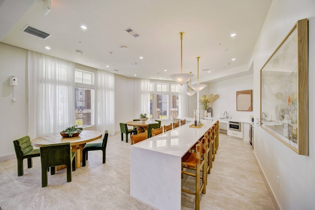 A modern kitchen with a dining table and chairs.