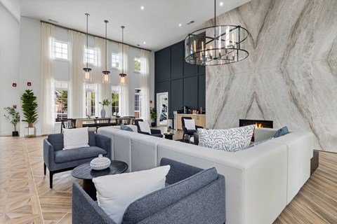 A modern living room with a grey sofa and a black coffee table.