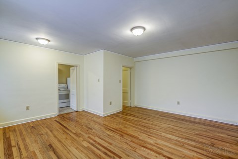 A room with wooden floors and white walls.