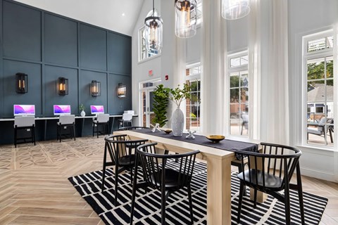 A modern dining area with a long table and chairs.